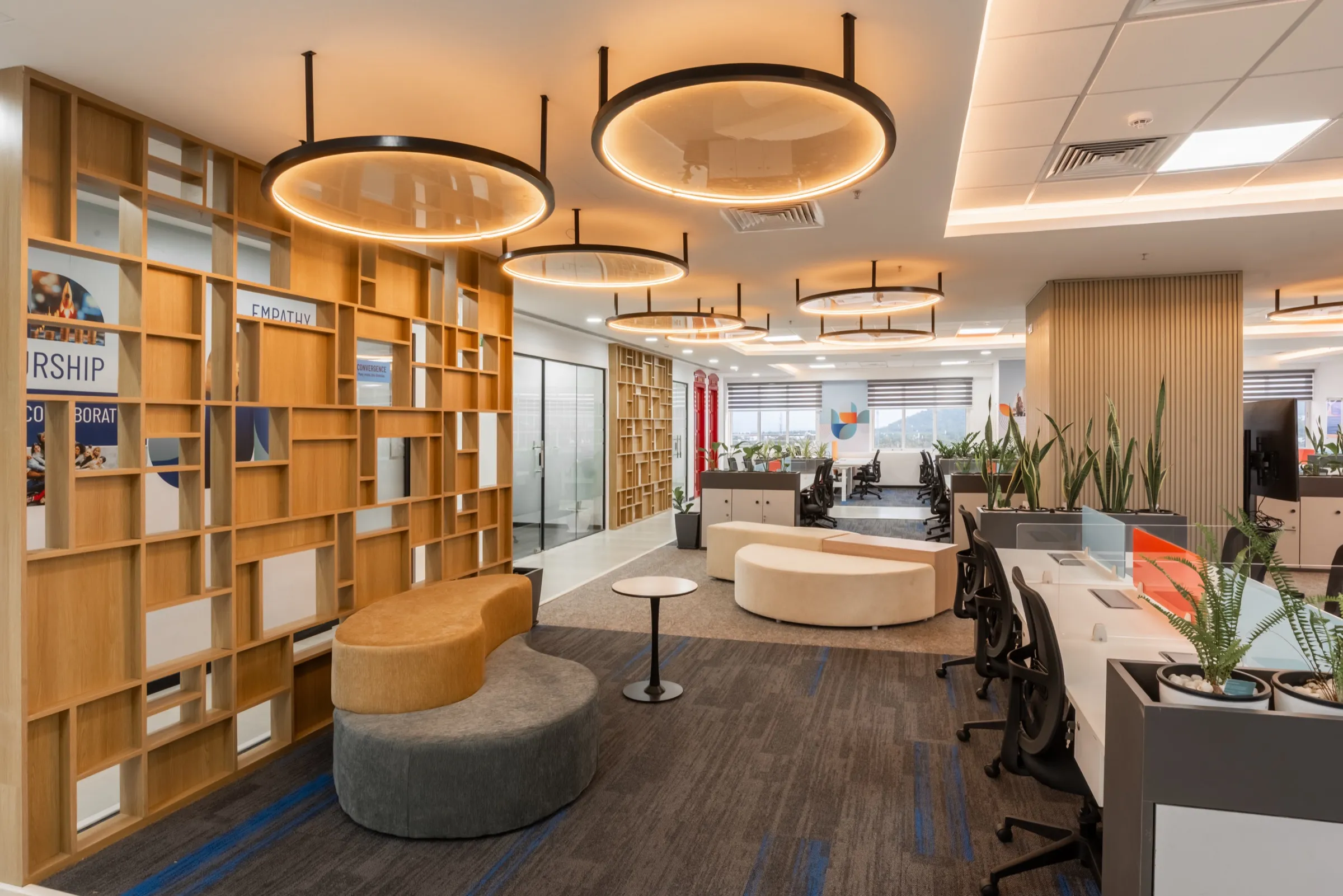 Library and breakout area with timber shelving and circular pendant lights